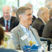 Guest smiling at a speaker at the Foundation Annual Meeting
